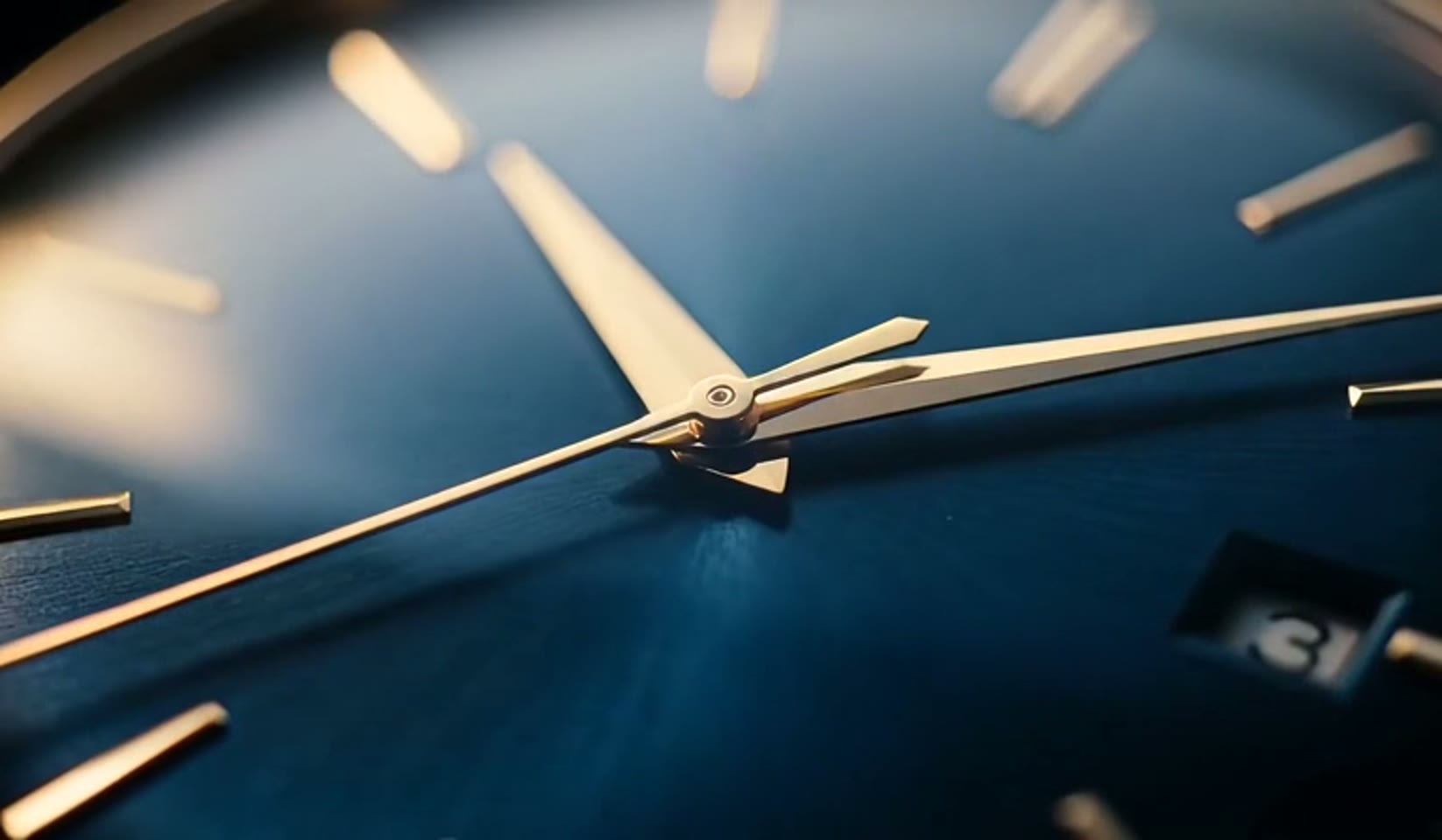 Macro of a luxury watch dial on wet marble